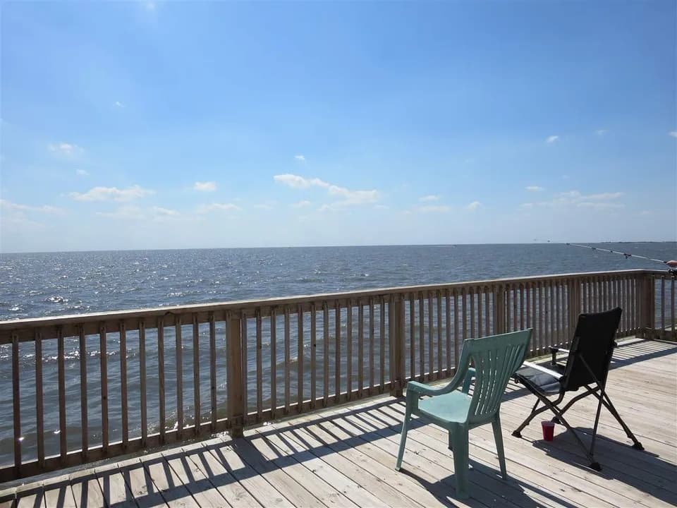 Deck overlooking Delaware Bay at Fortescue with fishing rod and open water